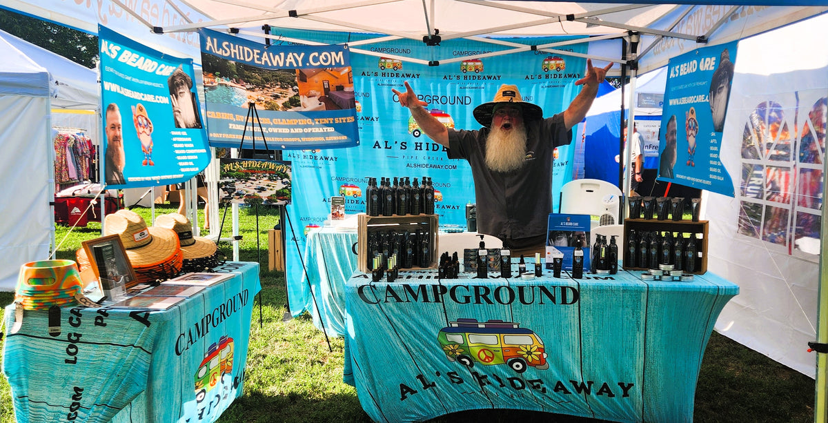 Person at a booth with 'Al's Hideaway' branding at an outdoor event.